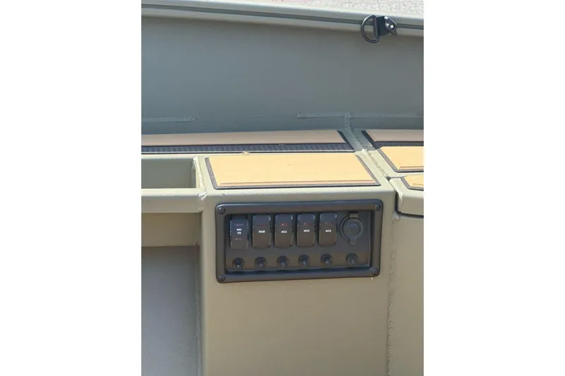 Slide: The Image of Control panel of 2026 Tracker Grizzly 1756 T Marsh boat, featuring multiple switches. - 7