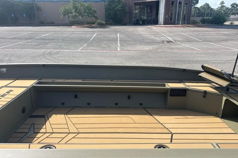 Slide: The Image of 2026 Tracker Grizzly 1756 T Marsh boat interior in an empty parking lot. - 5