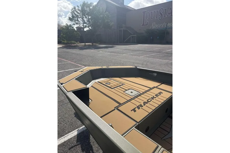 Slide: The Image of 2026 Tracker Grizzly 1756 T Marsh boat in parking lot, sunny day. - 4