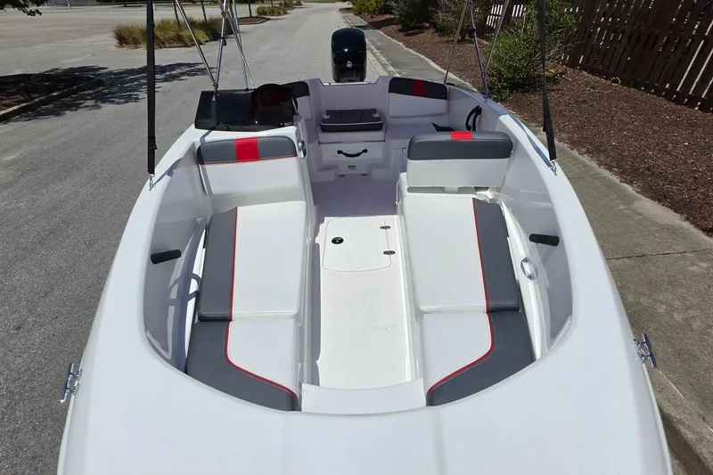Slide: The Image of 2026 Tahoe T16 boat interior with white and gray seating, red accents, and open deck layout. - 11