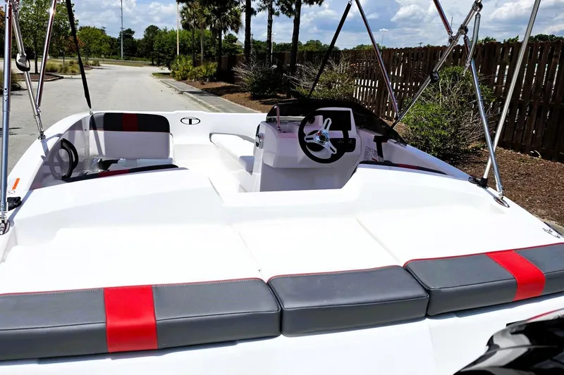 Slide: The Image of 2026 Tahoe T16 boat interior with sleek seating and modern steering wheel design. - 12