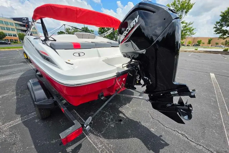 Slide: The Image of 2026 Tahoe T16 boat with Mercury outboard motor on a trailer in a parking lot. - 4