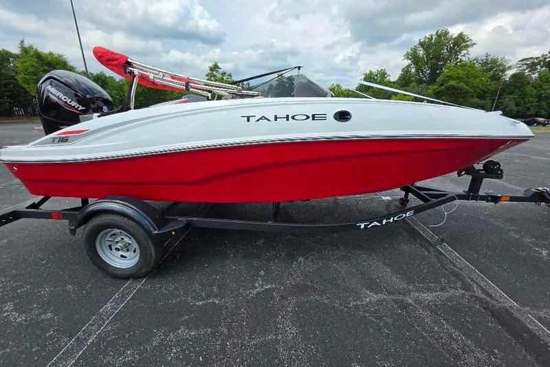 Slide: The Image of 2026 Tahoe T16 boat with red and white design on a trailer in a parking lot. - 1