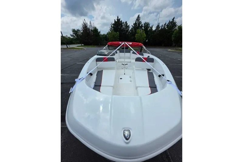 Slide: The Image of 2026 Tahoe T16 boat in parking lot, featuring sleek white design and red accents. - 8