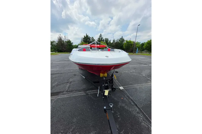 Slide: The Image of 2026 Tahoe T16 boat on trailer, parked outdoors under cloudy sky. - 7