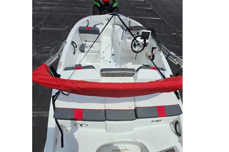 Slide: The Image of 2026 Tahoe T16 boat interior with red and gray seating, steering wheel, and controls. - 9