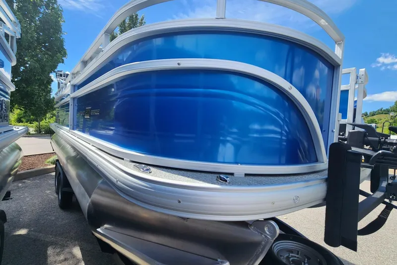Slide: The Image of 2026 Sun Tracker Fishin' Barge 20 DLX pontoon boat with sleek blue exterior. - 1