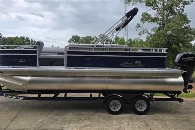 Slide: The Image of 2026 Sun Tracker SportFish 20 DLX pontoon boat on trailer, parked outdoors. - 4