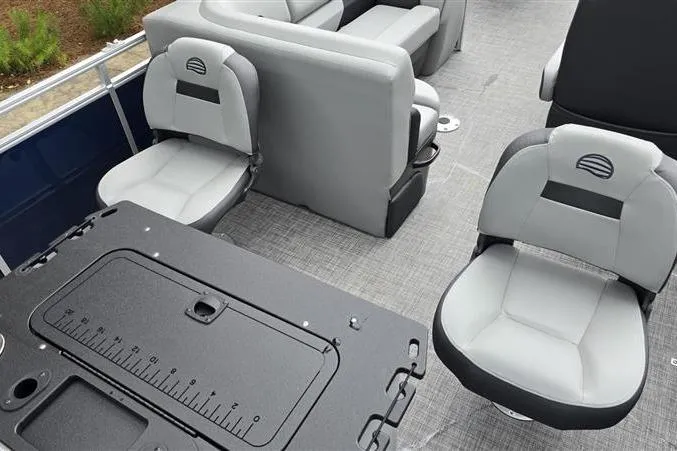 Slide: The Image of 2026 Sun Tracker SportFish 20 DLX interior with gray seating and fishing station. - 12
