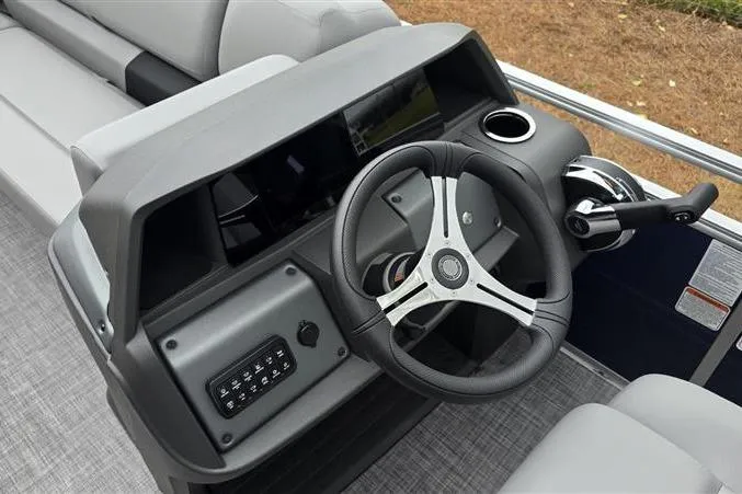 Slide: The Image of 2026 Sun Tracker SportFish 20 DLX dashboard with steering wheel and controls. - 11