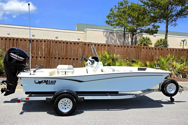 The Image of 2026 Mako Pro Skiff 15 CC boat on trailer, parked outdoors. - 0