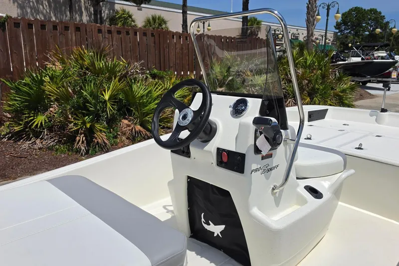 Slide: The Image of 2026 Mako Pro Skiff 15 CC boat interior with steering console and seating. - 10