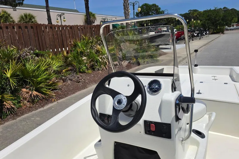 Slide: The Image of 2026 Mako Pro Skiff 15 CC boat console with steering wheel and controls. - 11