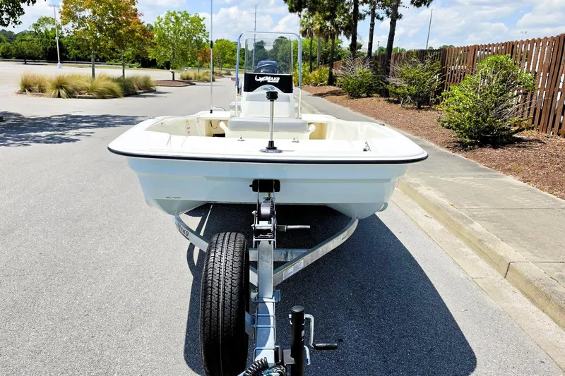 Slide: The Image of 2026 Mako Pro Skiff 15 CC boat on trailer, parked on a sunny street. - 12