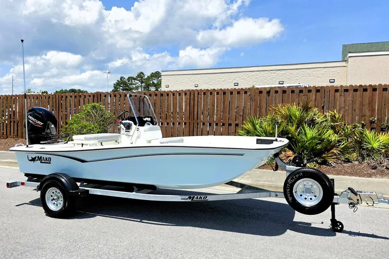 Slide: The Image of 2026 Mako Pro Skiff 15 CC boat on trailer, parked outdoors under a clear sky. - 3