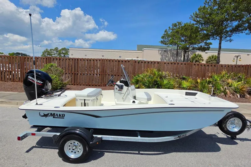 Slide: The Image of 2026 Mako Pro Skiff 15 CC boat on trailer, outdoors, sunny day. - 4