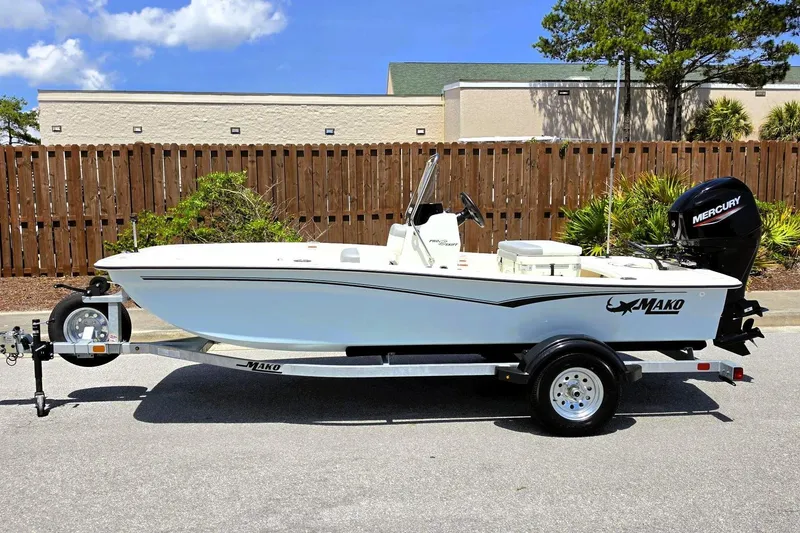 Slide: The Image of 2026 Mako Pro Skiff 15 CC boat on trailer, parked outdoors. - 6