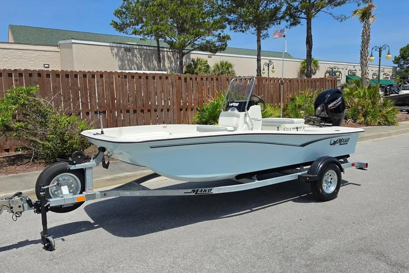 Slide: The Image of 2026 Mako Pro Skiff 15 CC boat on trailer, parked outdoors. - 7