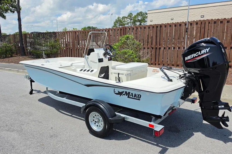 Slide: The Image of 2026 Mako Pro Skiff 15 CC boat with Mercury outboard motor on trailer. - 8