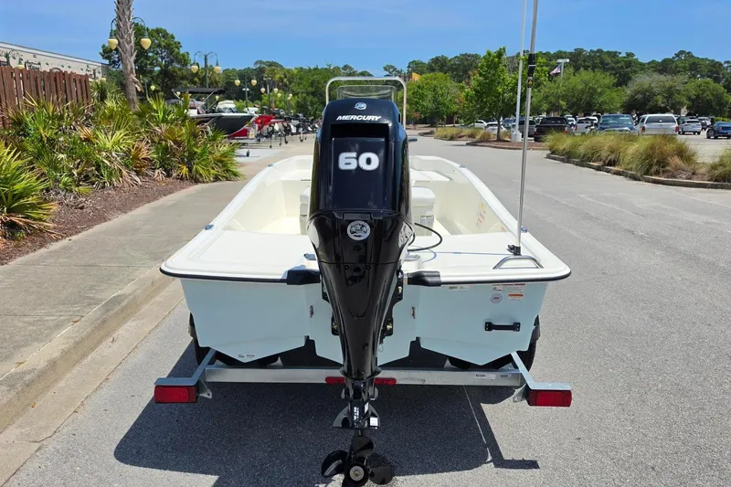 Slide: The Image of 2026 Mako Pro Skiff 15 CC with Mercury 60 engine on trailer in parking lot. - 9