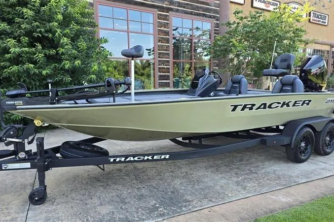 The Image of 2026 Tracker Savage 215 boat on trailer, parked outdoors near building. - 0