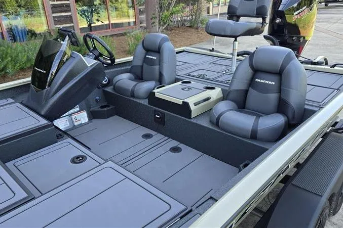 Slide: The Image of 2026 Tracker Savage 215 boat interior with gray seating and modern dashboard design. - 10