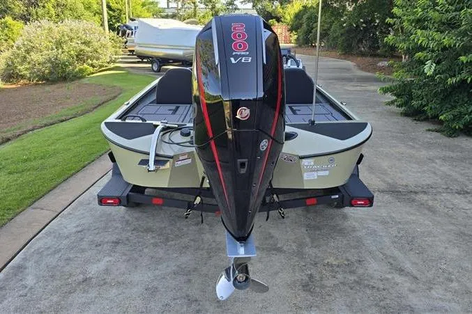 Slide: The Image of 2026 Tracker Savage 215 boat with powerful 200 V8 engine, parked on a driveway. - 3
