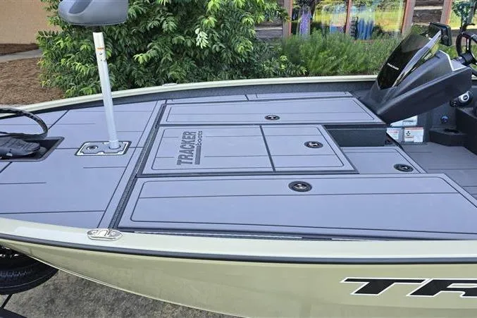 Slide: The Image of 2026 Tracker Savage 215 boat deck with storage compartments and steering console. - 7