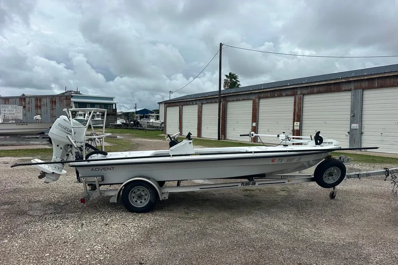 Slide: The Image of 2024 Ankona Advent boat on trailer, parked outdoors under cloudy skies. - 1
