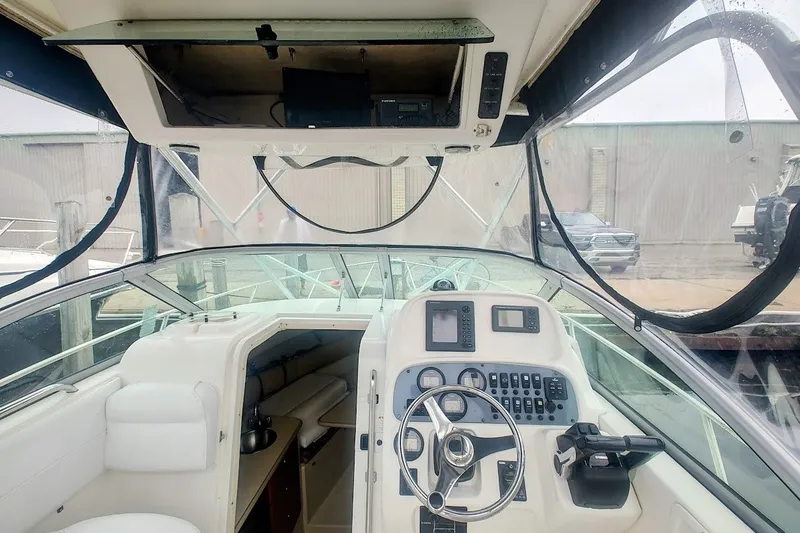 Slide: The Image of 2005 Robalo R265 Walkaround boat cockpit with steering wheel and control panel. - 10