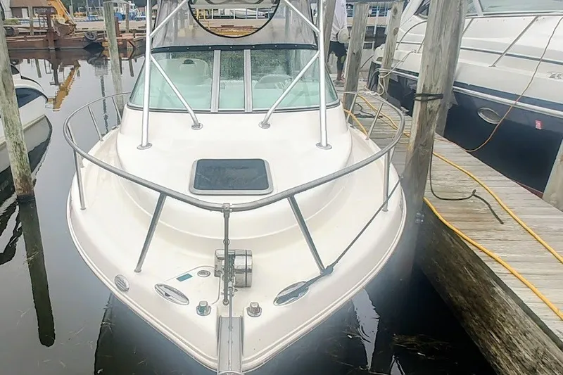 Slide: The Image of 2005 Robalo R265 Walkaround boat docked at marina, front view. - 3