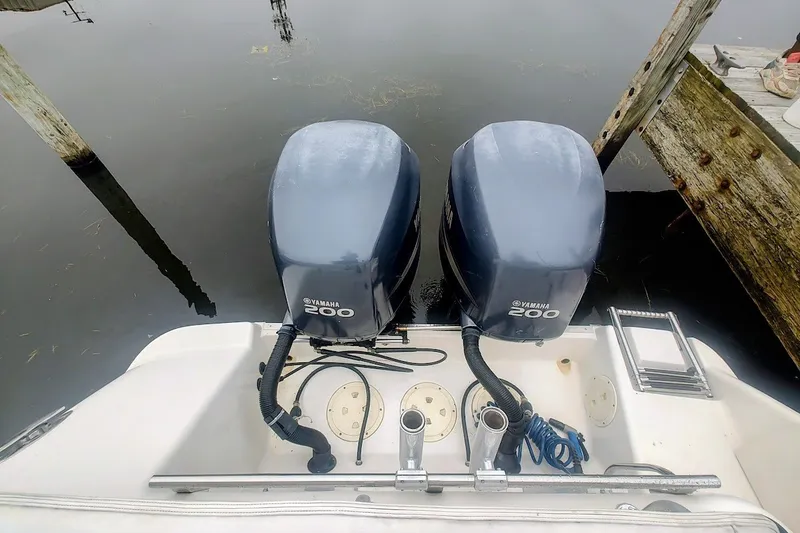 Slide: The Image of Twin Yamaha 200 engines on a 2005 Robalo R265 Walkaround boat at a dock. - 17