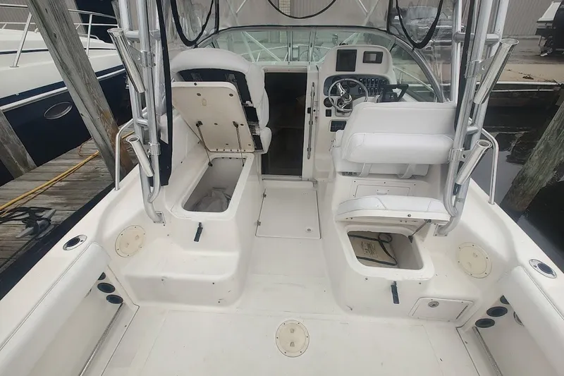 Slide: The Image of 2005 Robalo R265 Walkaround boat interior with seating and storage compartments. - 11