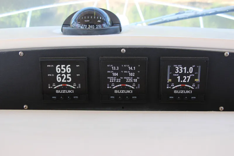 Slide: The Image of Dashboard of a 2005 Grady-White Express 330 with Suzuki engine displays. - 11