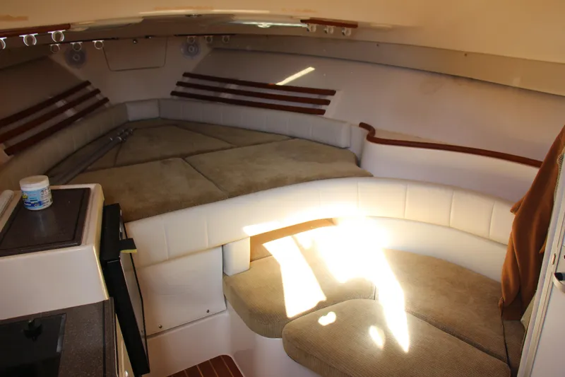 Slide: The Image of 2005 Grady-White Express 330 cabin interior with seating and kitchenette. - 13