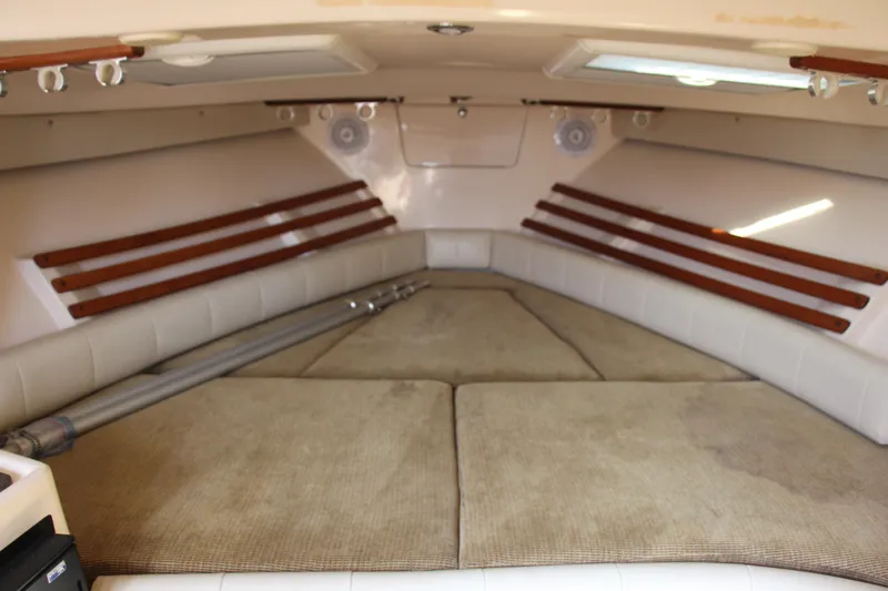 Slide: The Image of 2005 Grady-White Express 330 cabin interior with cushioned seating and wooden accents. - 14