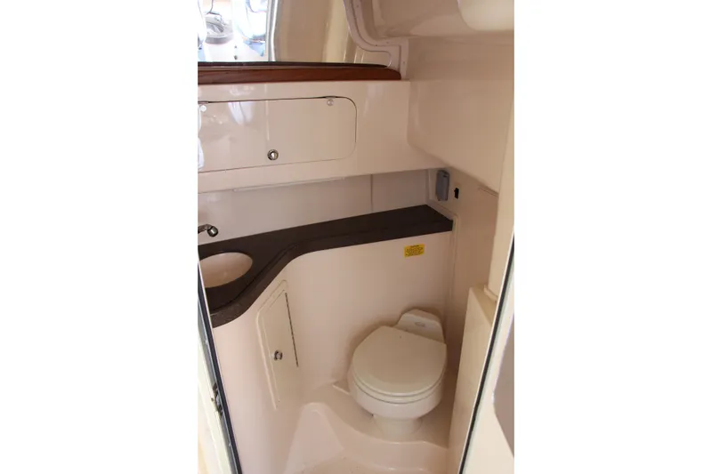 Slide: The Image of 2005 Grady-White Express 330 boat bathroom interior with sink and toilet. - 15