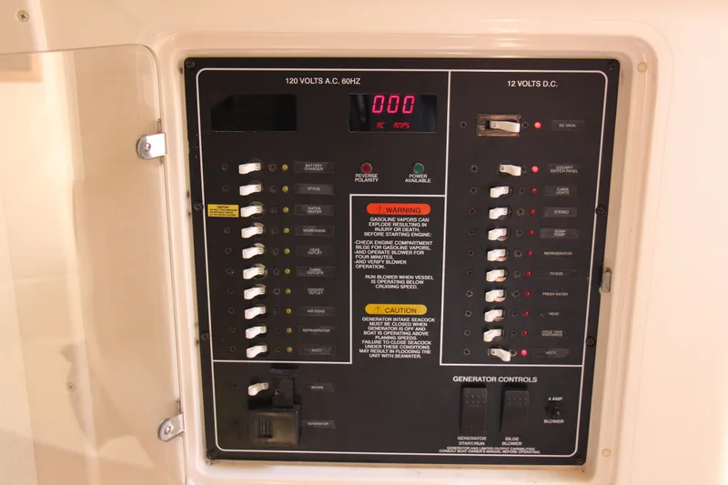 Slide: The Image of Electrical control panel on a 2005 Grady-White Express 330 boat, featuring switches and warnings. - 17