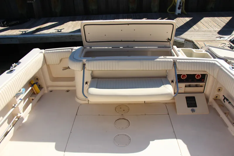 Slide: The Image of 2005 Grady-White Express 330 boat interior with open storage compartment and seating. - 18