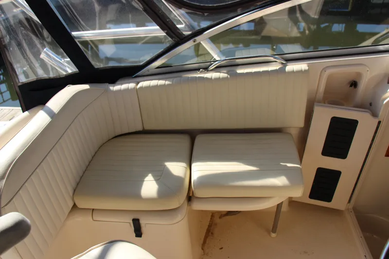 Slide: The Image of 2005 Grady-White Express 330 boat interior with beige seating and storage compartments. - 21