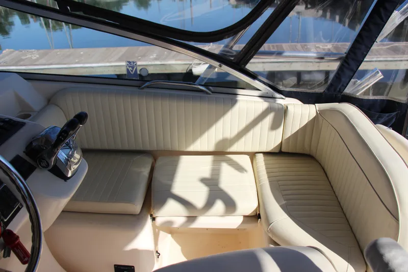 Slide: The Image of 2005 Grady-White Express 330 boat interior with beige seating and steering wheel. - 22