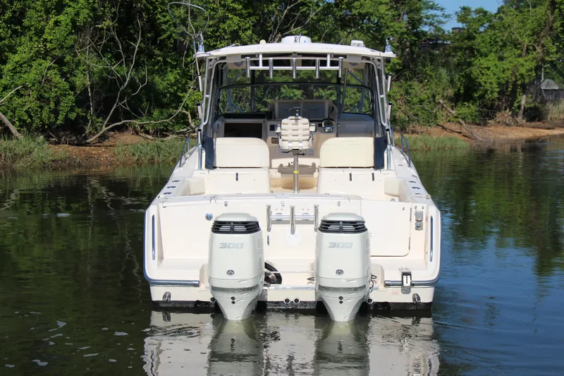 Slide: The Image of 2005 Grady-White Express 330 boat with dual engines on calm water. - 6