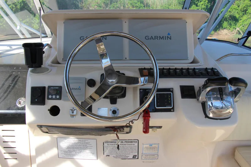 Slide: The Image of 2005 Grady-White Express 330 helm with Garmin navigation and control panel. - 8