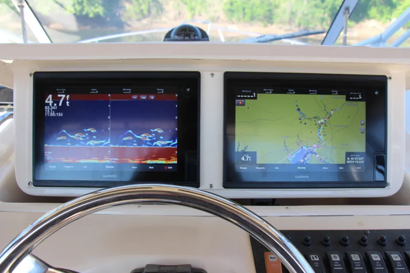 Slide: The Image of Dashboard of a 2005 Grady-White Express 330 with dual Garmin displays. - 9