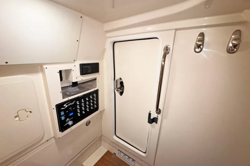 Slide: The Image of 2021 Scout 305 LXF interior cabin with control panel and storage compartments. - 13