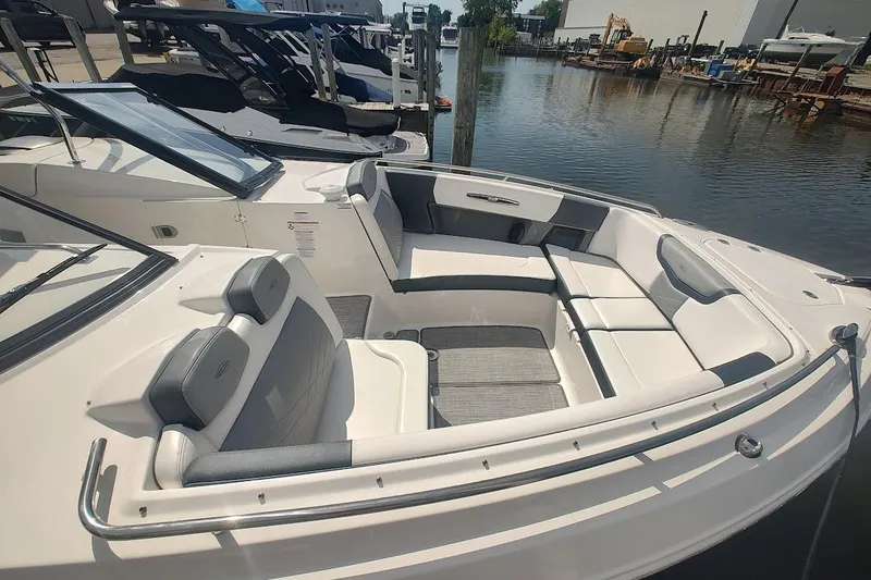 Slide: The Image of 2021 Chaparral 347 SSX boat with spacious seating, docked by the water. - 15
