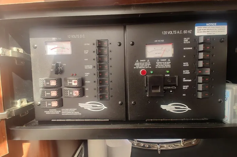 Slide: The Image of Electrical control panel of a 2021 Chaparral 347 SSX boat, featuring AC and DC switches. - 17