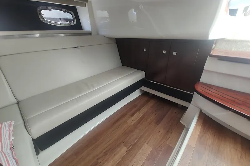 Slide: The Image of 2021 Chaparral 347 SSX interior with sleek seating and wooden flooring. - 19