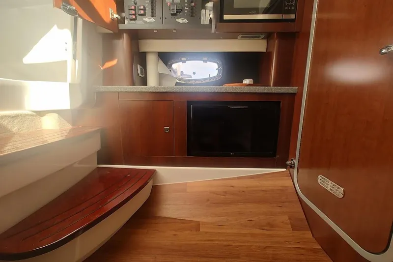 Slide: The Image of Interior of 2021 Chaparral 347 SSX boat with wood flooring and modern amenities. - 20
