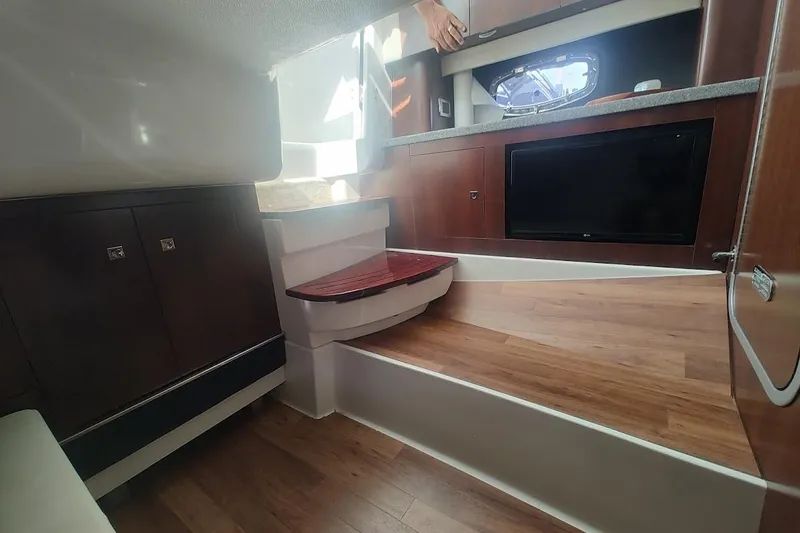 Slide: The Image of 2021 Chaparral 347 SSX cabin interior with wood flooring and modern cabinetry. - 21